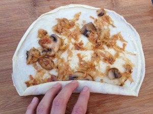 rolling up cabbage and mushroom crepes 