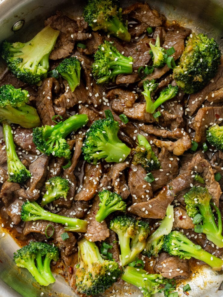 image of close up beef and broccoli garnished with white sesame seeds and green onions