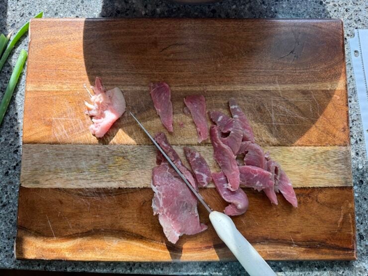 image of thinly sliced round eye of steak for beef and broccoli