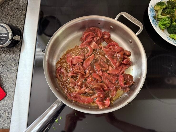 image of beef slices being browned in a pan