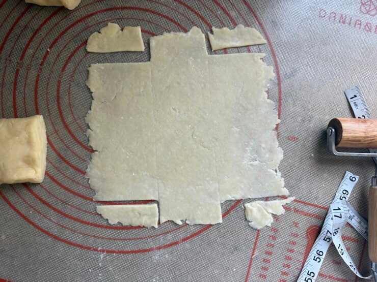 image of pie dough with the four corners removed to make a chevron braided pastry