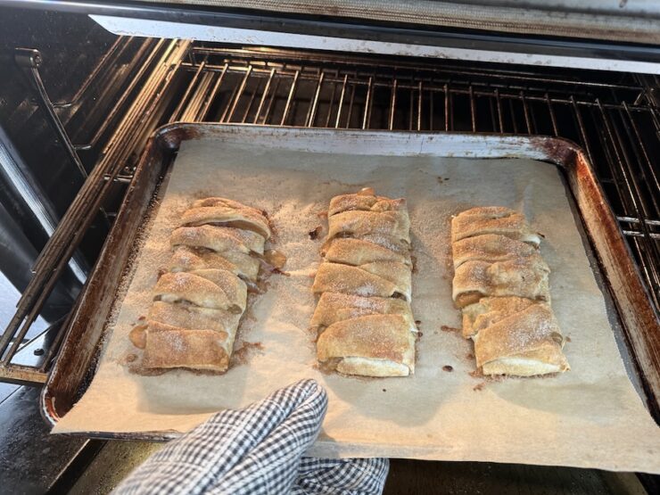 image of baked braided apple hand pies being removed from the oven