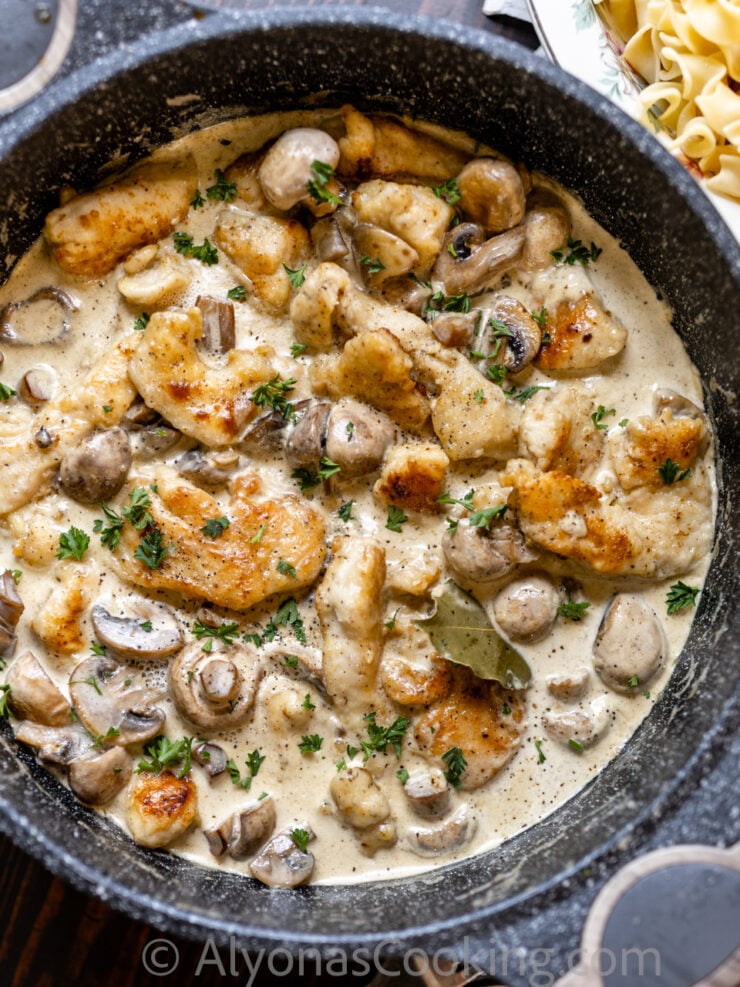 image of smothered chicken with a cream gravy, and whole mushrooms 