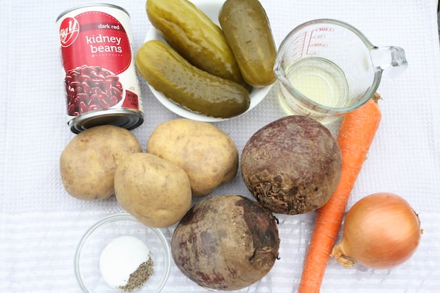 ingredients for vinaigrette Ukrainian salad (Vinegret): Kidney beans, dill pickles, potatoes, beets, carrot, onion, salt, pepper, and sunflower oil.