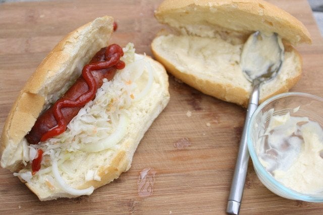 Ukrainian style hot dogs (bratwursts with sauerkraut, carrots, mayonnaise, ketchup, raw onions)