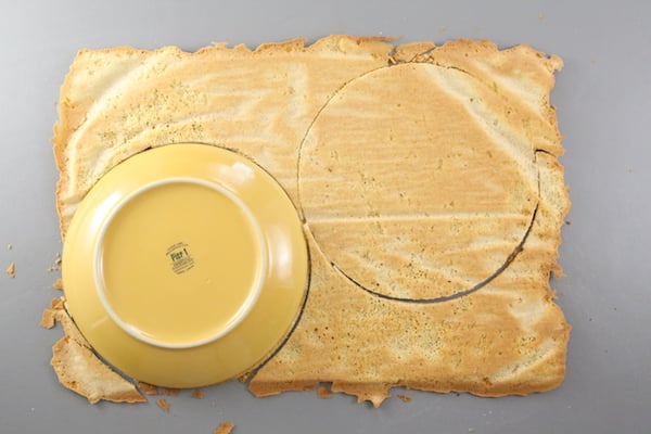 Russian honey cake layers cut out with a plate to make a round honey cake