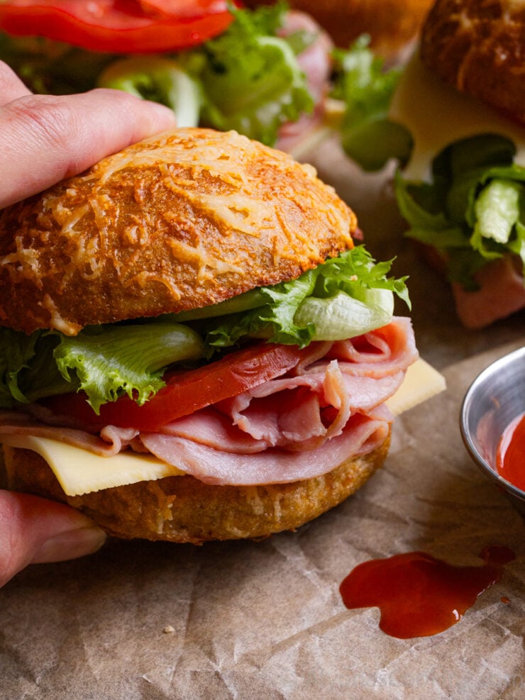 image of chef Alyona holding an asiago bagel sandwich