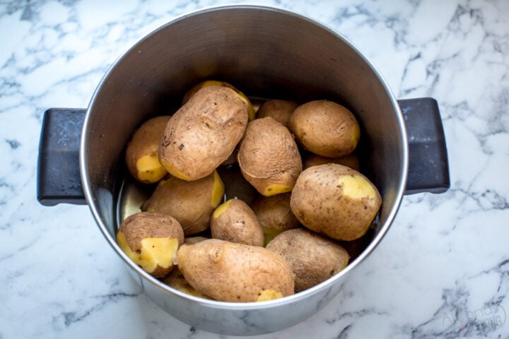 whole potatoes in a pot par boiled in water