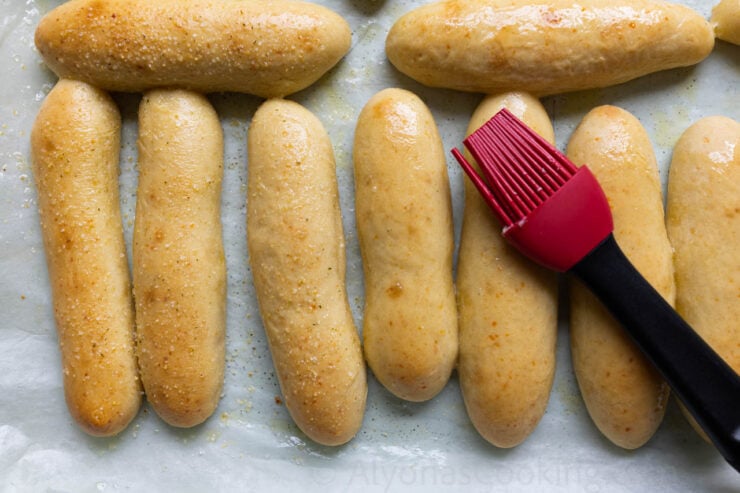 image of copycat Olive Garden breadsticks brushed with butter and sprinkled with garlic salt