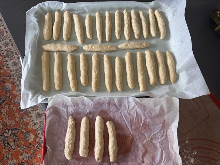 Image of rolled copycat Olive Garden breadsticks on a cookie sheet
