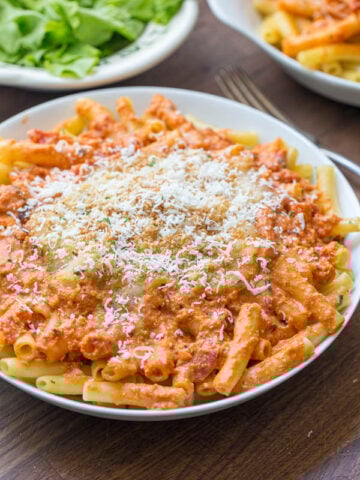 five cheese ziti al forno olive garden copycat on a plate with cheese blend and breadcrumbs