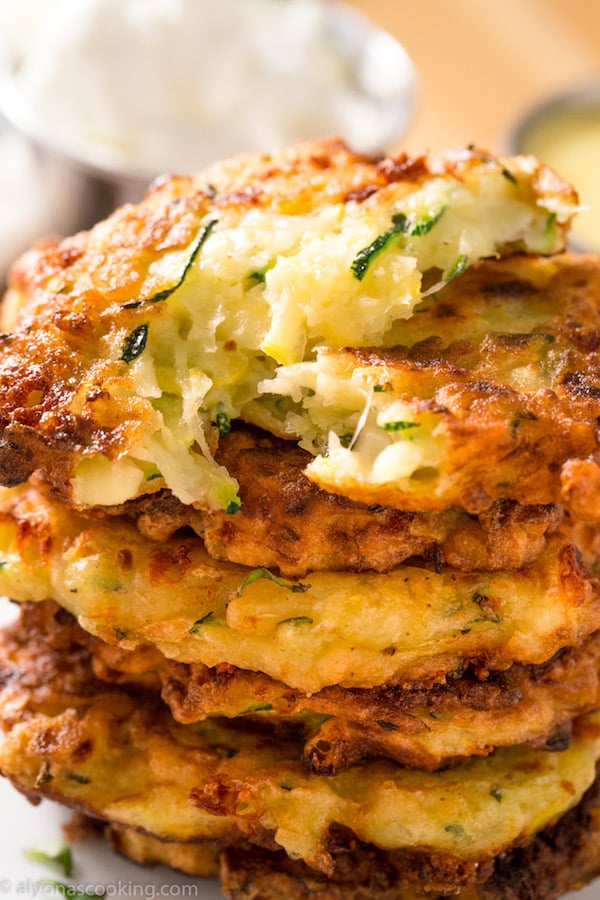 A plate of golden brown zucchini fritters ready to be served