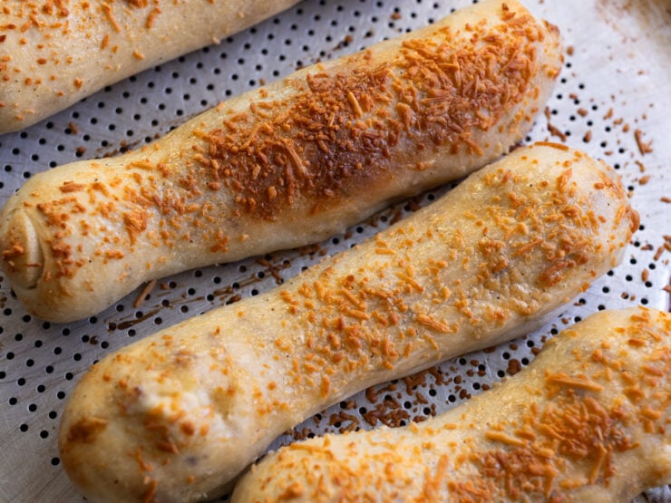 a horizontal image of homemade Costco chicken bakes made with homemade pizza dough and Caesars dressing