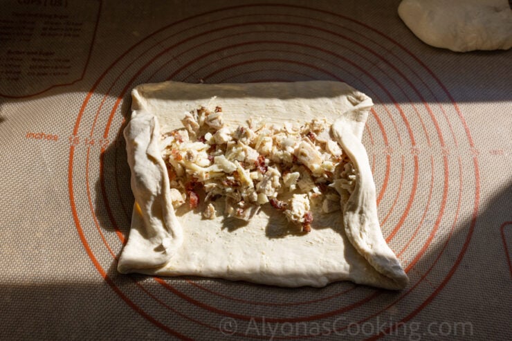 image of rolling up a Costco Chicken Bake (burrito-style)