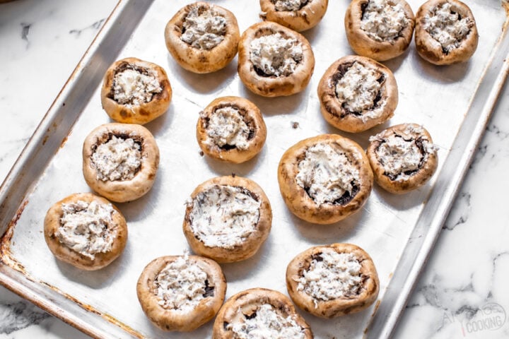 stuffed mushrooms caps on a baking sheet pan