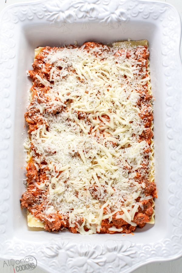 layered lasagna casserole in white baking dish