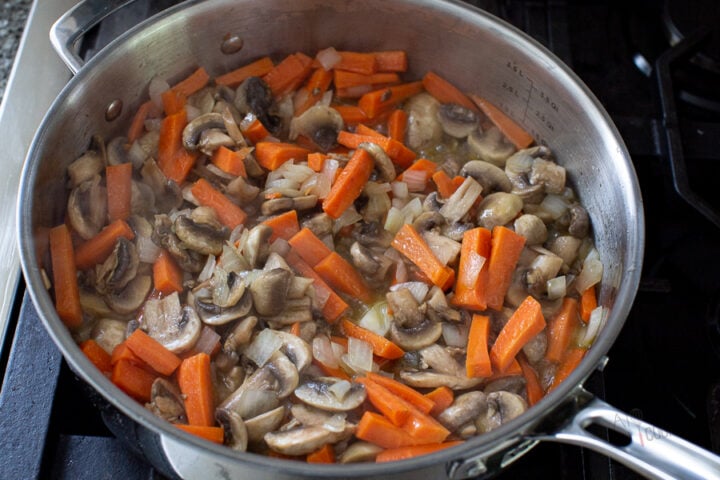 mushrooms and vegetables sautéed in a pan for mushroom pilaf