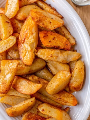 seasoned oven baked potato wedges on a plate