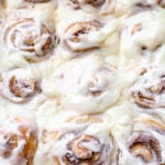 cinnamon rolls like cinnabons copycat in a white baking dish with a cream cheese frosting