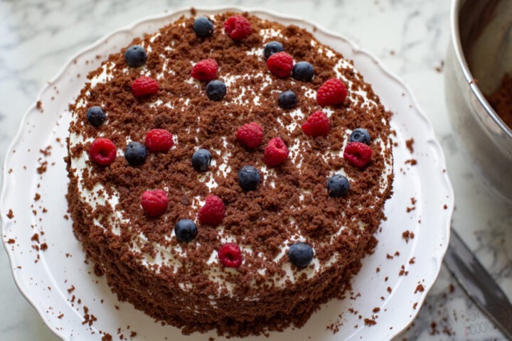 german chocolate cake mix garnished with leftover crumbs and a cream cheese frosting with cool whip