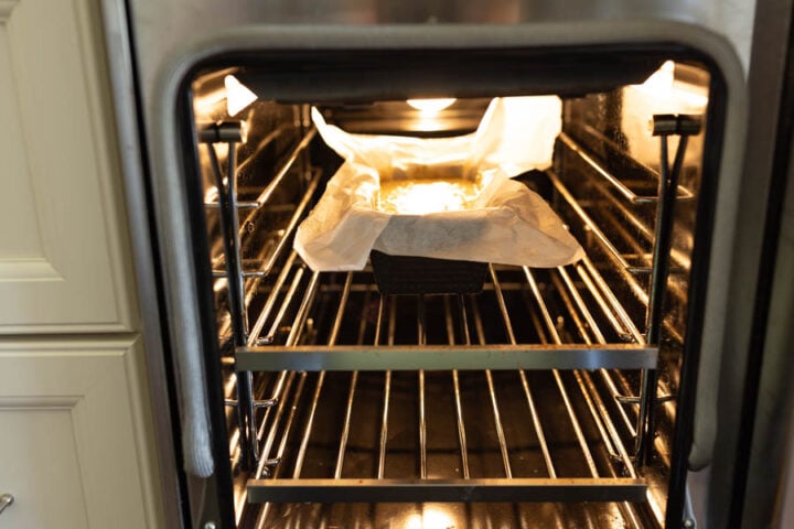 banana bread placed in the center rack of an oven to bake