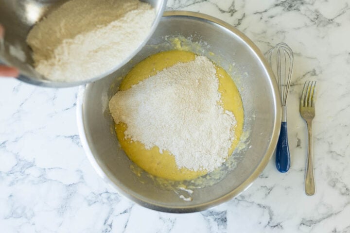 Combining the dry ingredients to the wet ingredients for banana bread