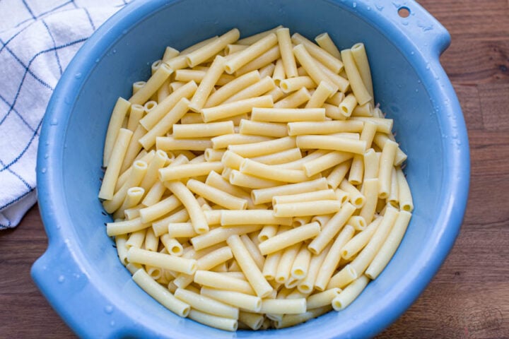 cooked ziti pasta in a colander strained from water