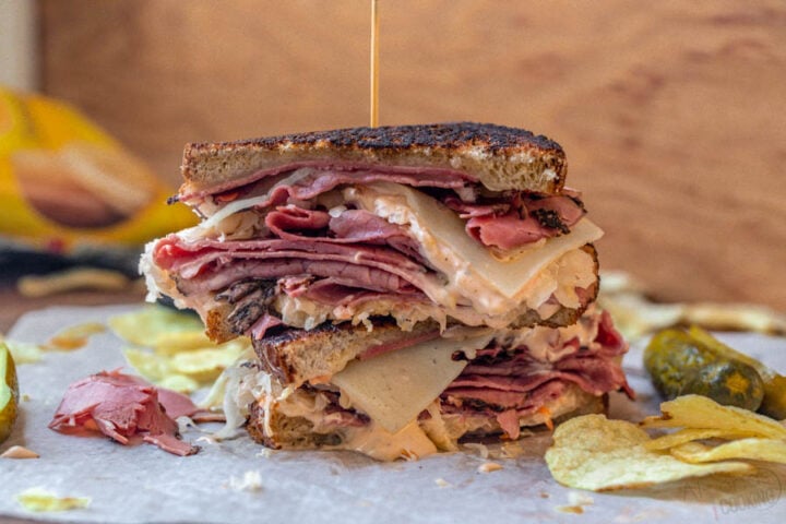 prepared Reuben sandwich made with pastrami, swiss cheese, thousand island, sauerkraut and rye bread