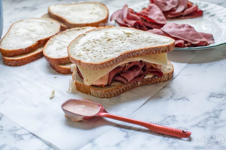 buttered slices of rye bread about to be grilled to make a homemade reuben sandwich recipe