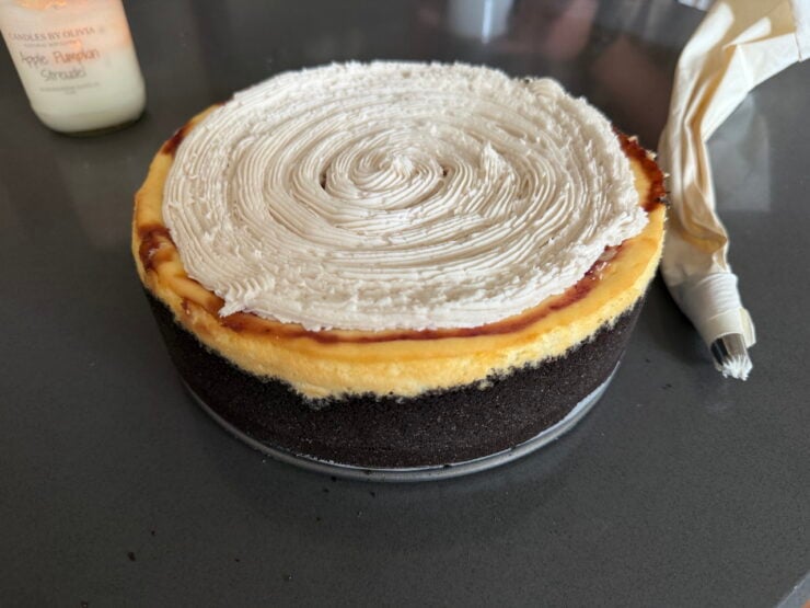 image of a white chocolate raspberry cheesecake iced with frosting