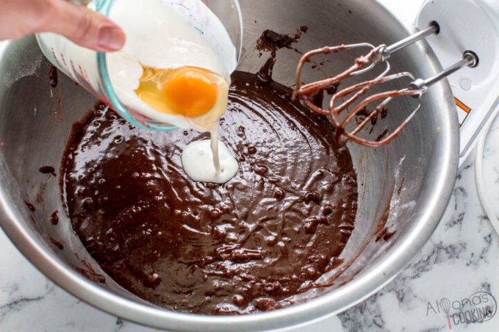 adding the eggs, vanilla, and buttermilk to the chocolate batter