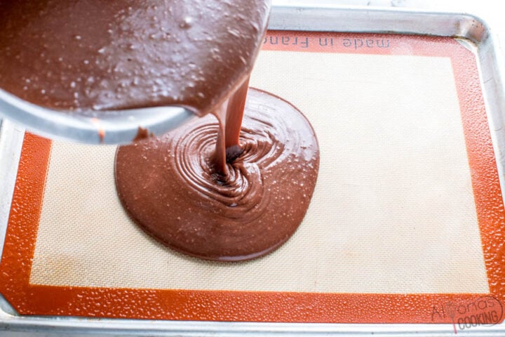 pouring the chocolate batter into a sheet pan