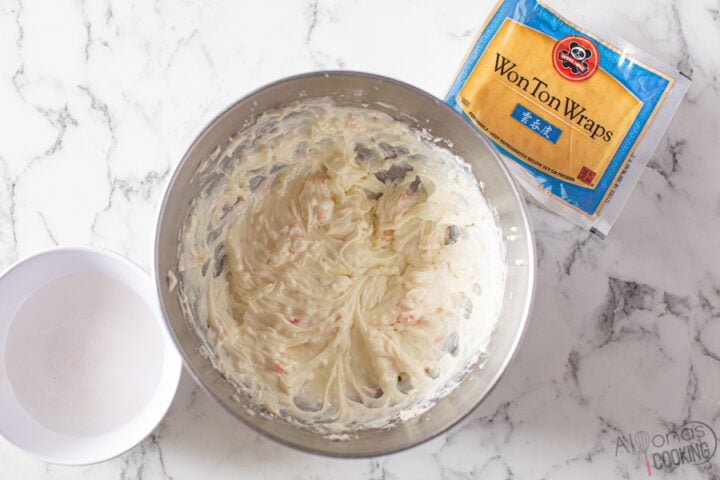 image: how to make crab rangoon filling with cream cheese, powdered sugar, and imitation crab meat. Step:1