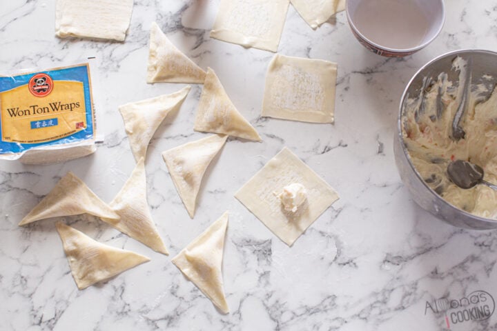 image: how to seal triangle shaped crab rangoon wontons