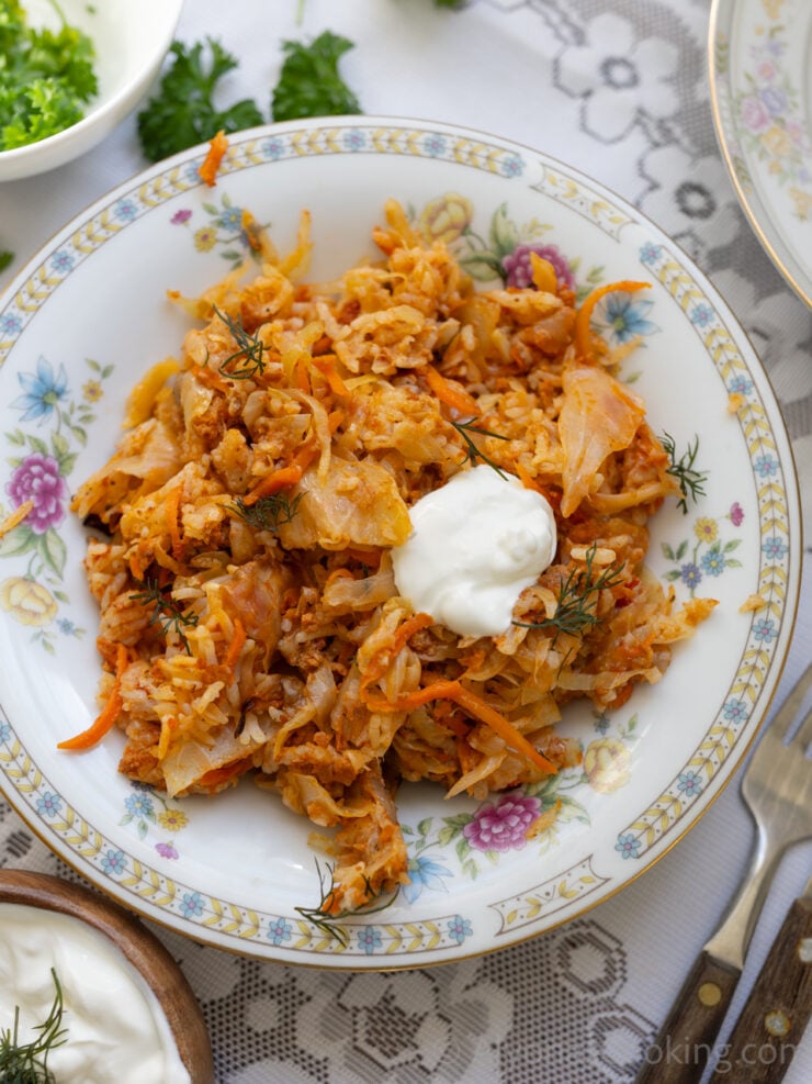 image of deconstructed cabbage rolls in a bowl dolloped with sour cream