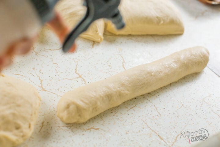 spray tops of sub roll dough