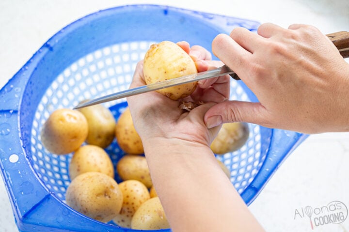 how to peel baby potatoes with a knife scraping off the skins