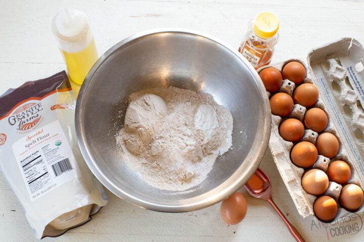 ingredients for healthy pancakes: egg, whole wheat flour, milk, honey, oil, salt, and baking powder