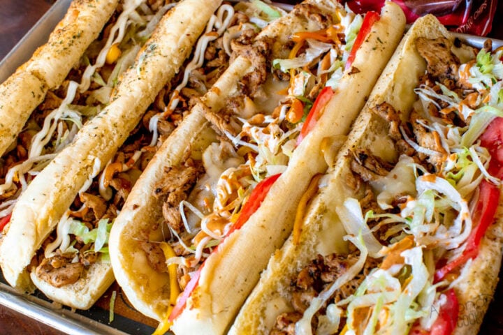 how to finish topping a Chicken Philly Cheesesteak sandwich