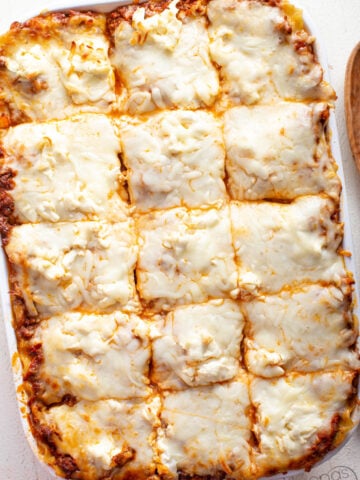 how to make lasagna with cream. The BEST lasagna recipe in a casserole pan with wide pasta sheets, meat sauce, grated cream cheese, and Mozzarella cheese