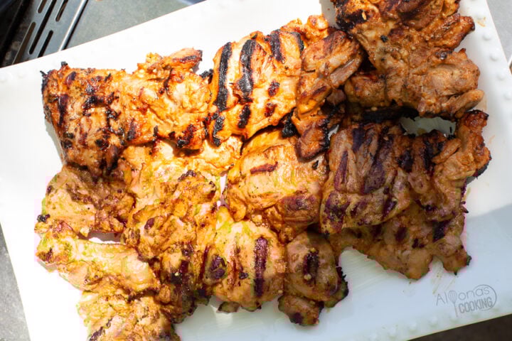 grilled chicken thighs resting on a plate