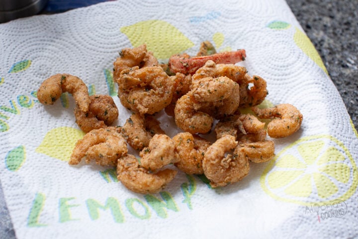 fried shrimp on a plate lined with paper towels