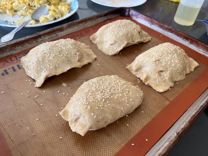 breakfast hot pockets brushed with egg wash and topped with sesame seeds