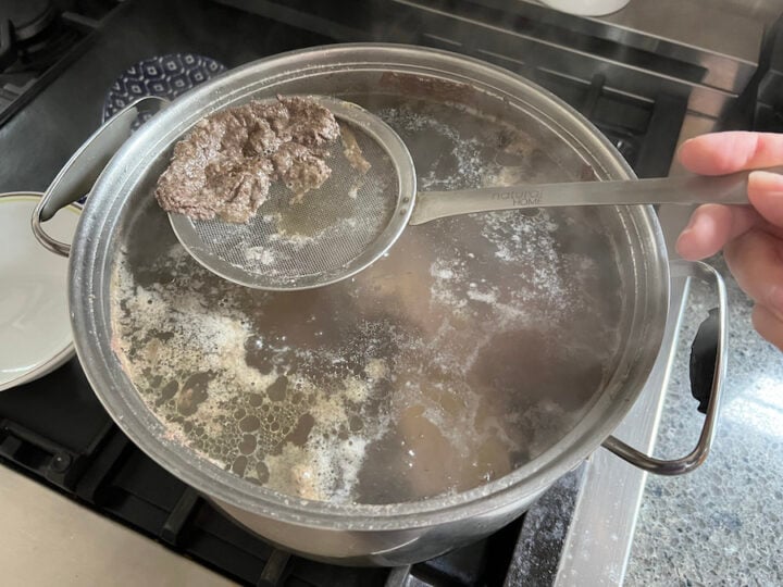 skimming off foam from split pea soup