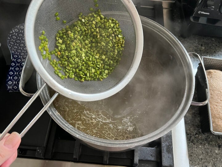 adding dry and rinsed split peas to a pot