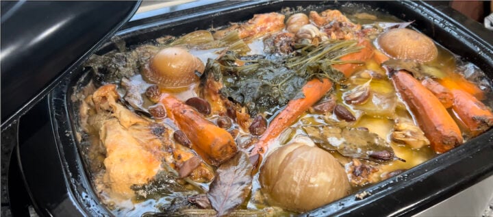 large batch of chicken broth in a roaster
