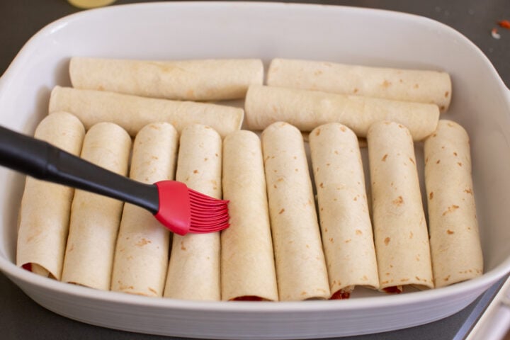 arranged pizza roll ups in a pan