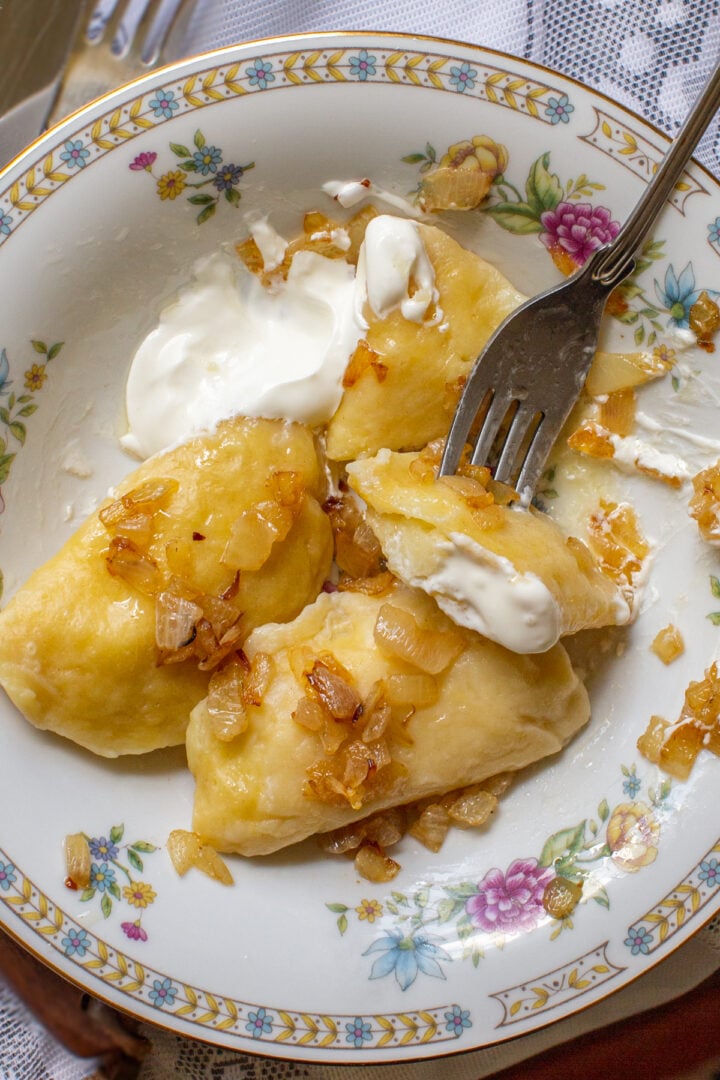 Pierogi with sour cream and onions