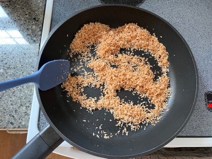 toasted coconut flakes in a skillet