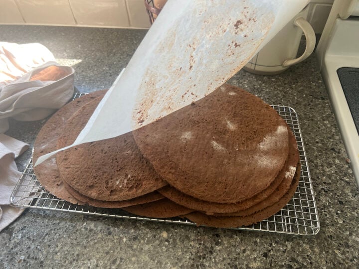 inverted Spartak cake layers on a cooling rack